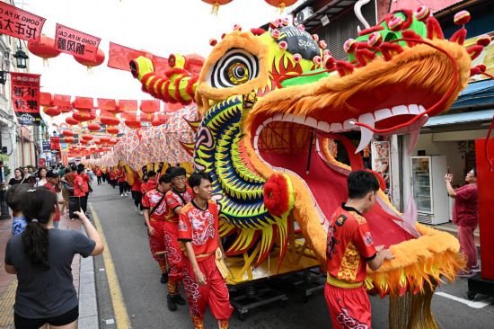 2月1日，由馬來西亞和中國的100多名青少年組成的舞龍隊(duì)在馬來西亞馬六甲市雞場街上共舞一條近200米的“長龍”。這是活動現(xiàn)場的“長龍”。新華社記者程一恒攝