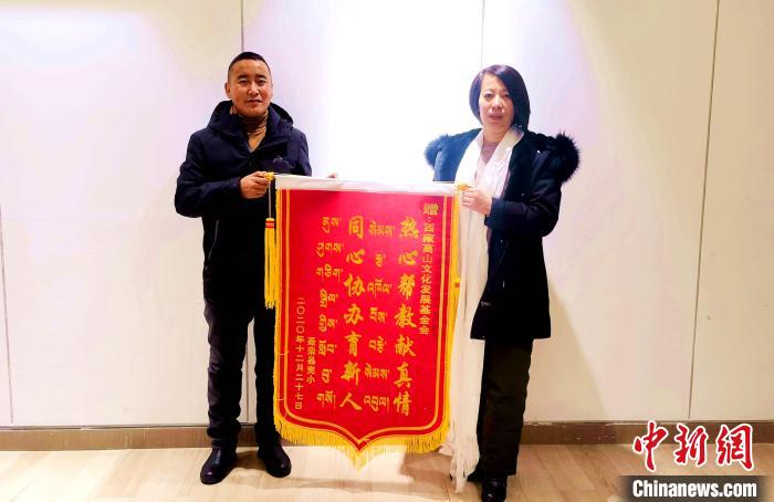 圖為聶榮縣完全小學向西藏高山文化發(fā)展基金會贈送錦旗?！∮谫e 攝