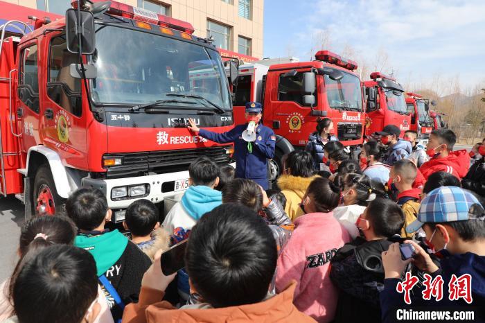圖為消防員向小朋友們講解消防車。　楊龍建 攝