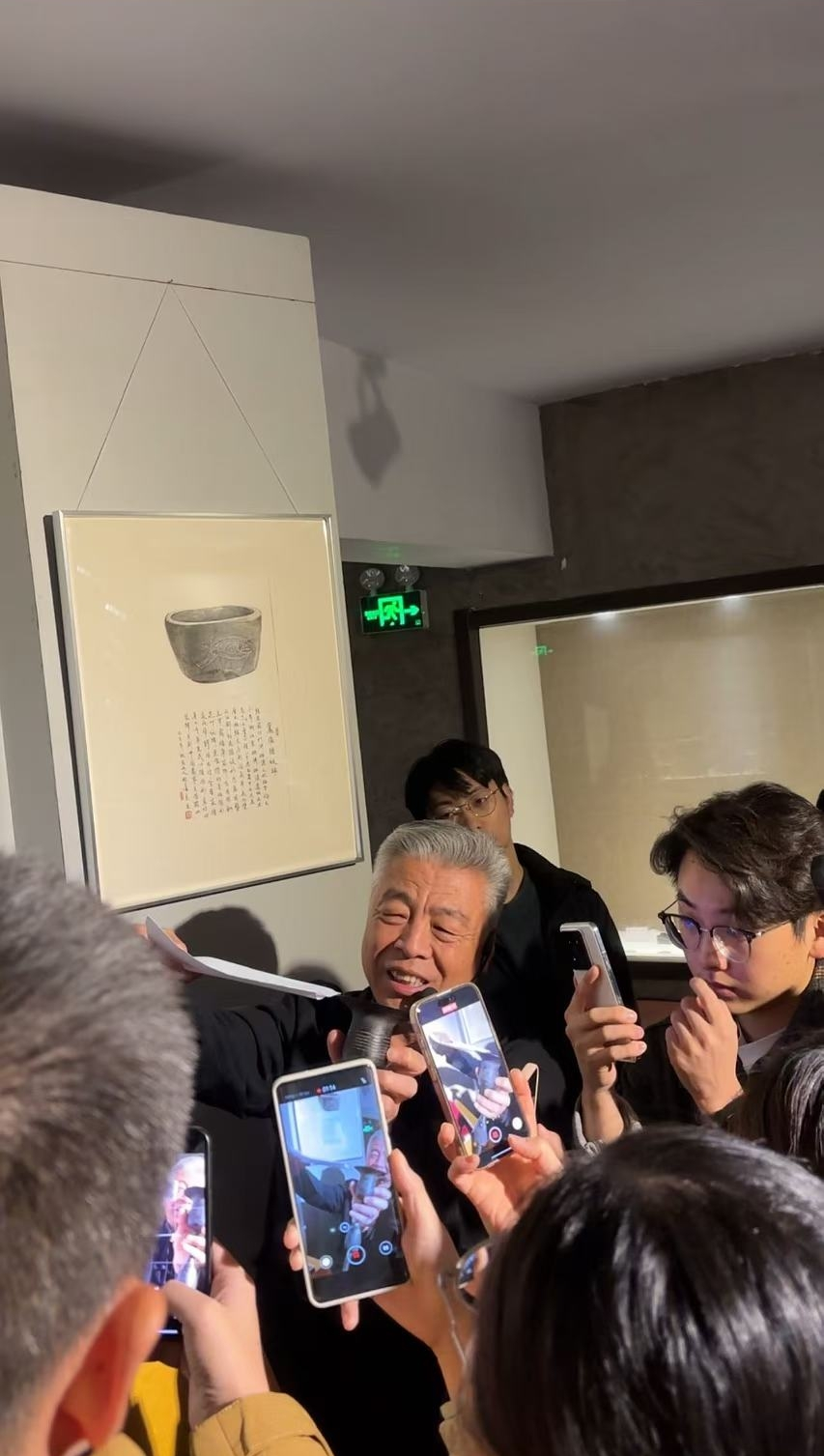 黑陶邢文化博物館館長邢葆東展示兩張相疊的A4紙，向記者解釋此為杯口的厚度。