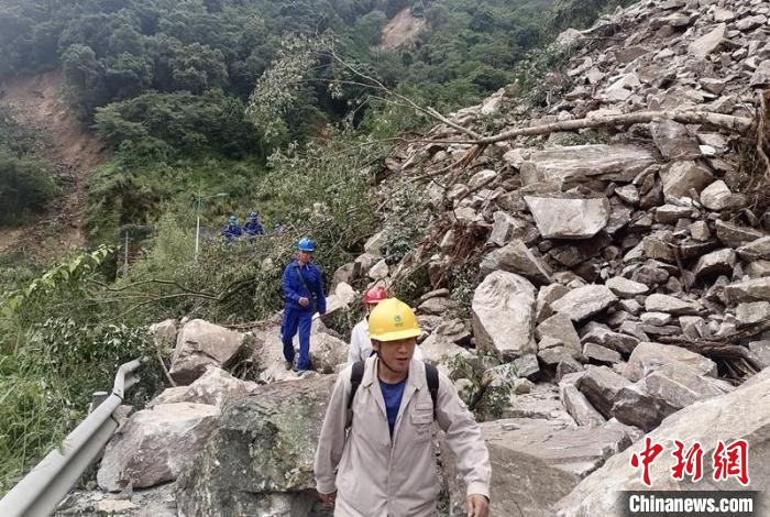 電力搶險(xiǎn)人員徒步通過(guò)垮塌路段?！∷拇娏﹫D