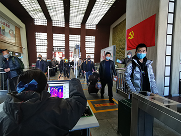 拉薩火車站工作人員對出站旅客進行紅外線測溫。趙越拍攝.jpg