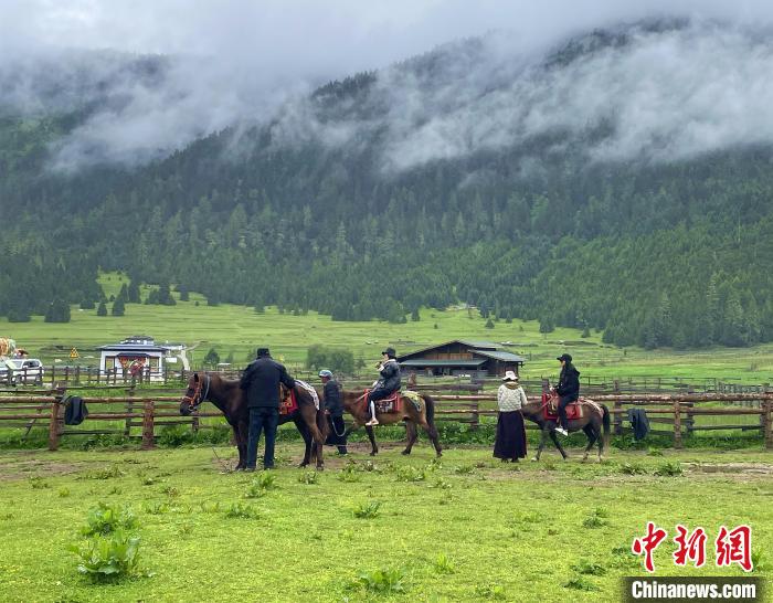 6月10日，游客在魯朗小鎮(zhèn)高山牧場景區(qū)體驗(yàn)騎馬?！∪轿木?攝